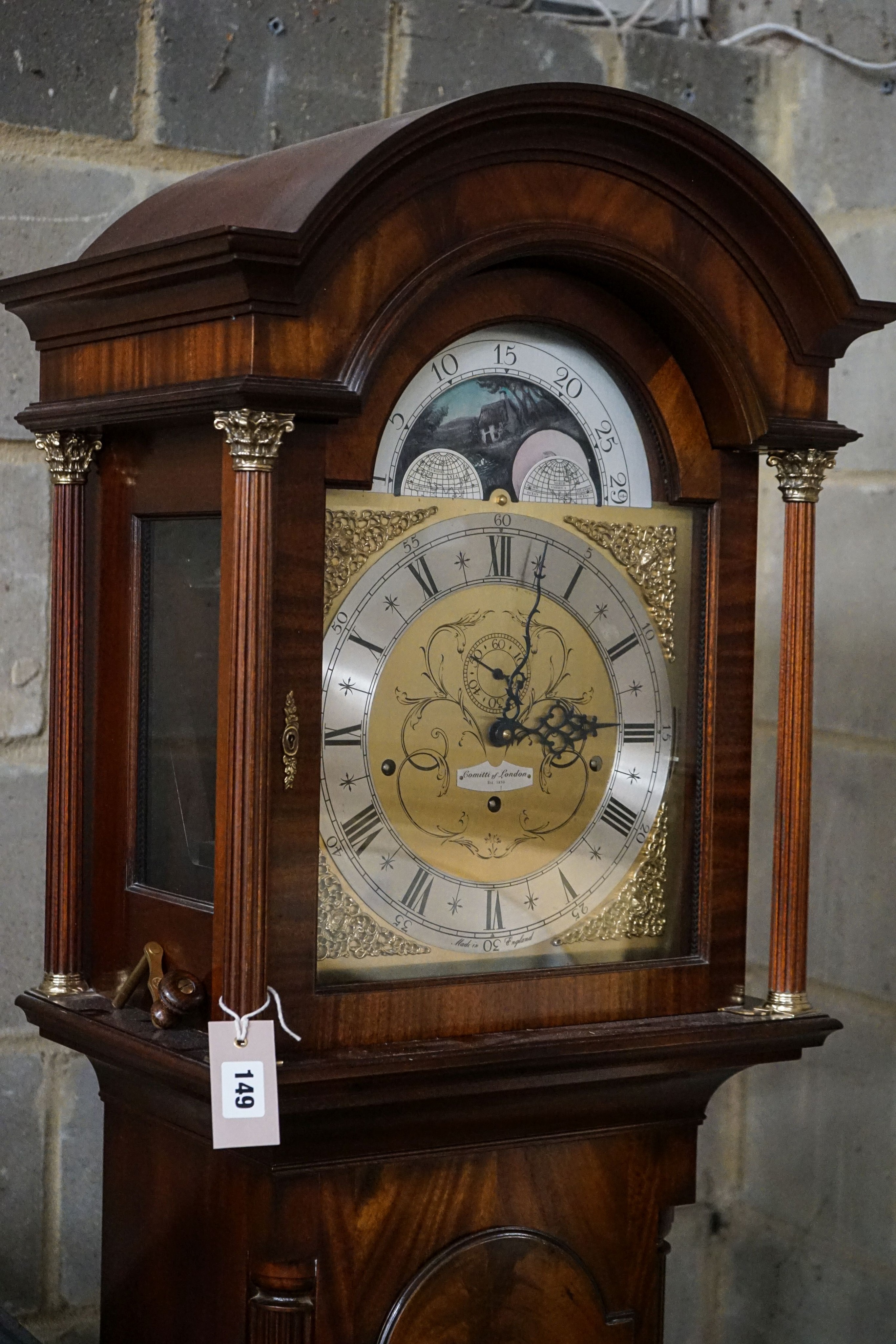 A modern mahogany longcase clock by Comitti London eight day, striking and chiming movement, brass dial with rocking ship automaton, the case with bulls-eye door, height 203cm